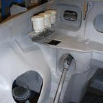 Exhaust cut out stiffener and hydraulic cylinder r